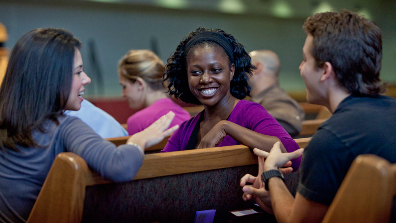 Students smiling in chapel