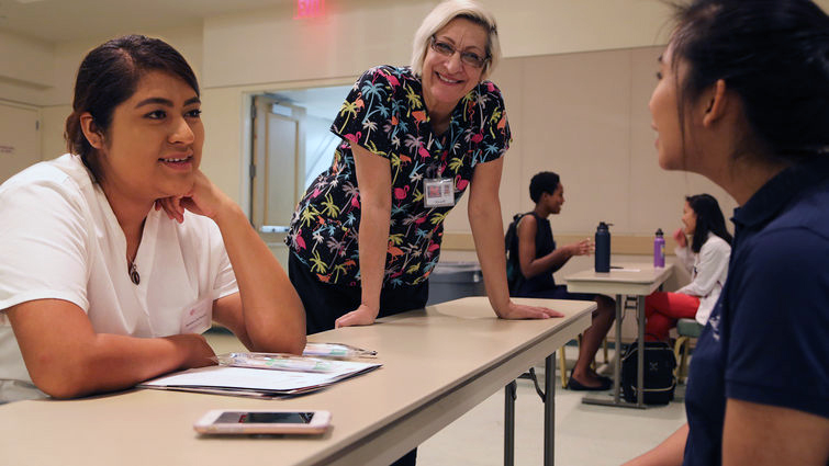 High school student speaking with healthcare professionals