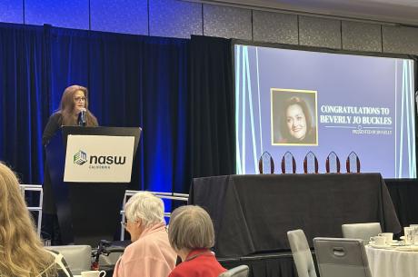 Dr. Buckles standing at podium