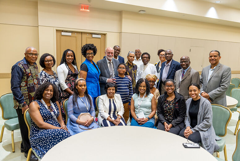 Black alumni smiling with Dr. Hart