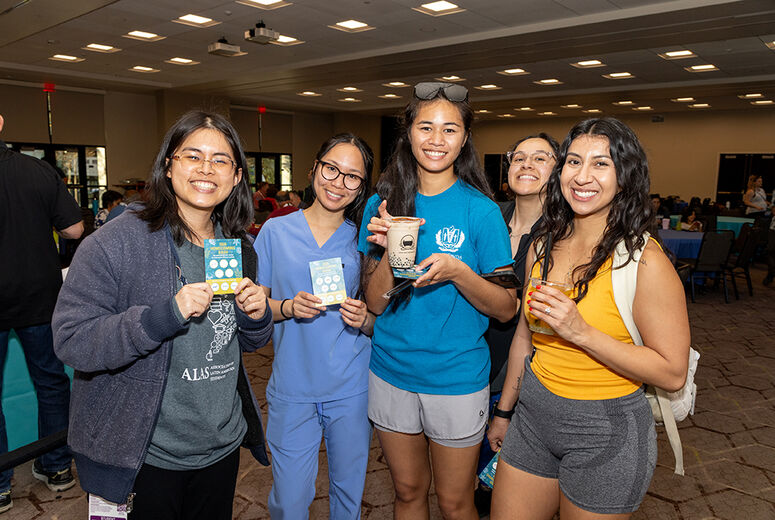 5 girls smiling holding various elements in hand