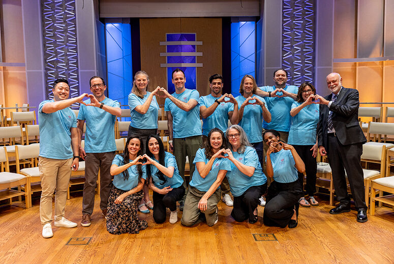 Volunteers making heart symbol with hands