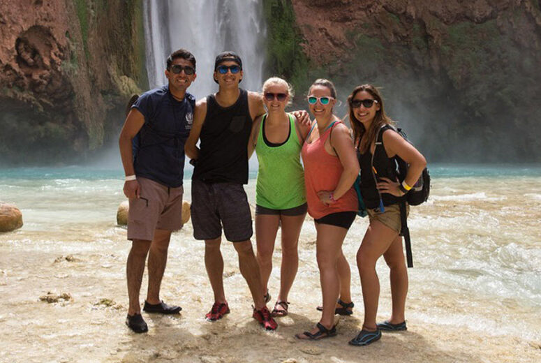 students on field trip next to waterfall