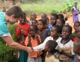 Partners and Services Sites - Physician with children in Africa